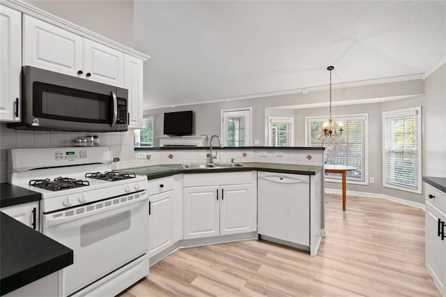 kitchen with white cabinets, white appliances, sink, and tasteful backsplash