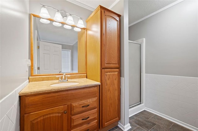 bathroom featuring vanity, tile patterned floors, an enclosed shower, and a textured ceiling