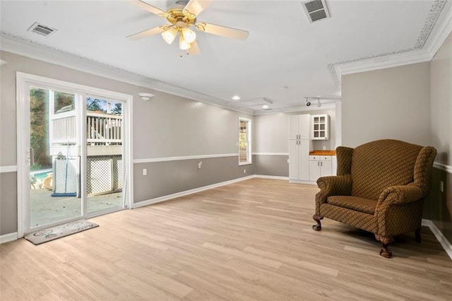 sitting room featuring light hardwood / wood-style floors, ceiling fan, and ornamental molding