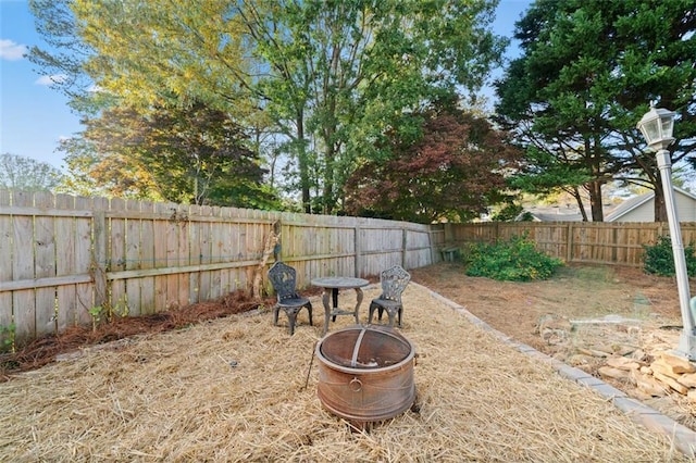 view of yard with a fire pit