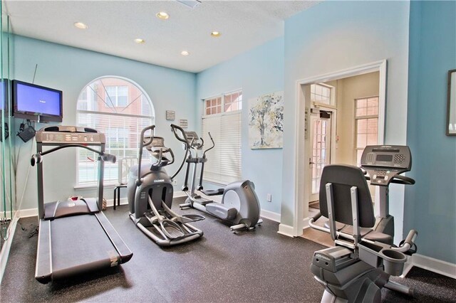 exercise area with recessed lighting and baseboards