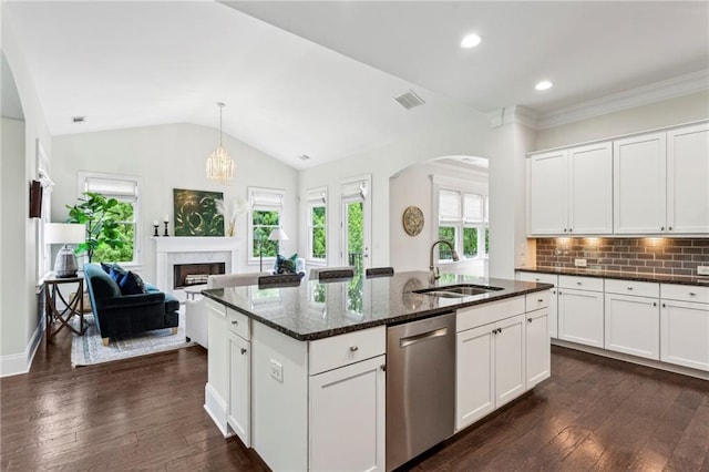1393 Kings Park Dr NW, Kennesaw, GA 30152 - kitchen featuring stainless steel dishwasher, a sink, arched walkways, a fireplace, and dark stone counters