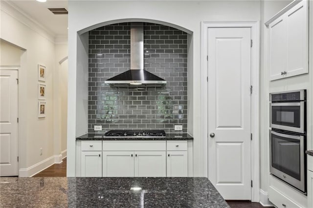 1393 Kings Park Dr NW, Kennesaw, GA 30152 - kitchen featuring wall chimney range hood, gas cooktop, double oven, dark stone countertops, and ornamental molding
