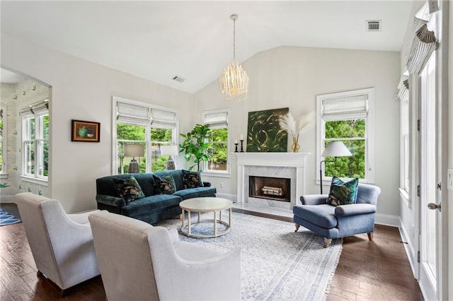 1393 Kings Park Dr NW, Kennesaw, GA 30152 - living room with dark wood-style flooring, vaulted ceiling, a high end fireplace, a chandelier, and arched walkways