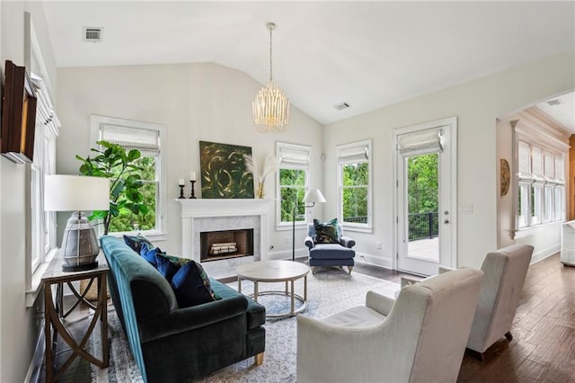 1393 Kings Park Dr NW, Kennesaw, GA 30152 - living area with plenty of natural light, lofted ceiling, a high end fireplace, arched walkways, and dark wood-style floors
