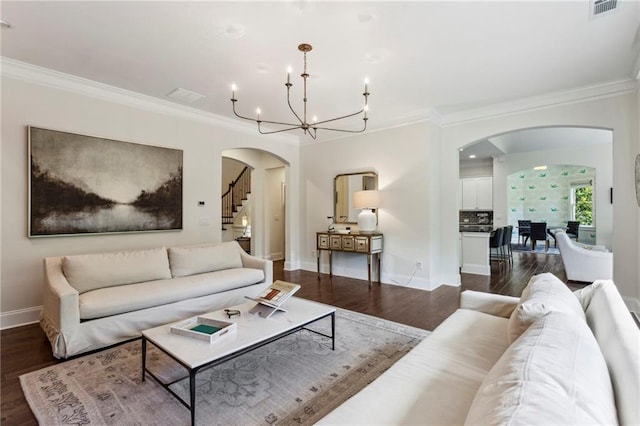 1393 Kings Park Dr NW, Kennesaw, GA 30152 - living room featuring arched walkways, a chandelier, crown molding, and dark wood-type flooring