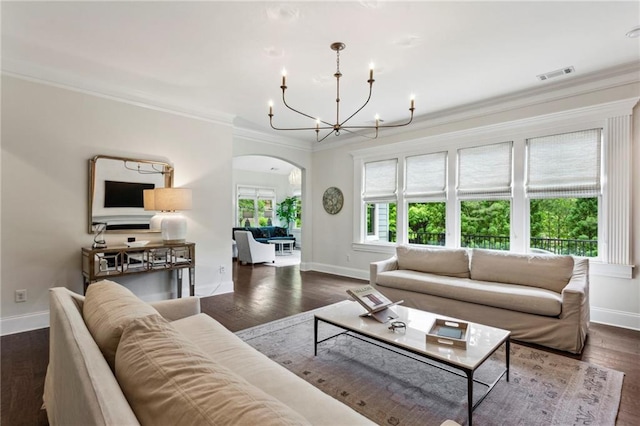 1393 Kings Park Dr NW, Kennesaw, GA 30152 - living area featuring arched walkways, a chandelier, baseboards, crown molding, and dark wood-style floors