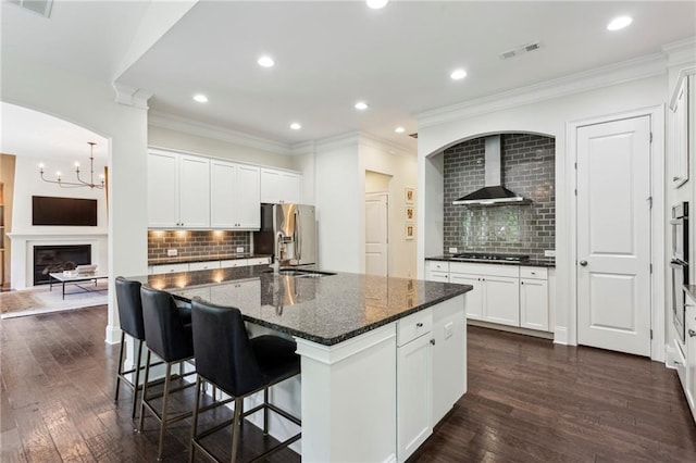 1393 Kings Park Dr NW, Kennesaw, GA 30152 - kitchen featuring decorative backsplash, stainless steel appliances, wall chimney exhaust hood, dark wood-type flooring, and recessed lighting