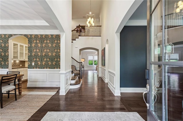 1393 Kings Park Dr NW, Kennesaw, GA 30152 - foyer with stairway, a chandelier, arched walkways, wood finished floors, and crown molding