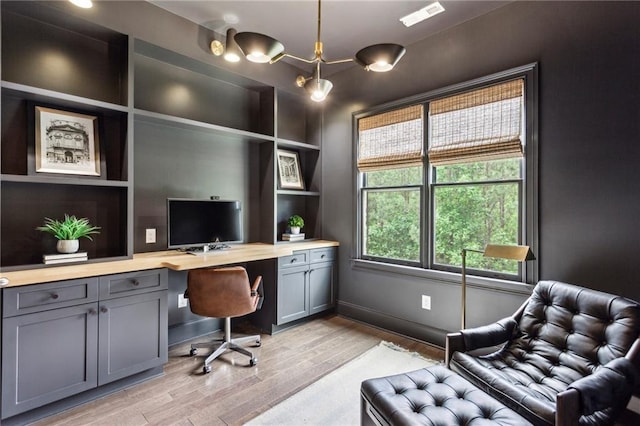 1393 Kings Park Dr NW, Kennesaw, GA 30152 - home office featuring light wood finished floors, built in desk, and baseboards