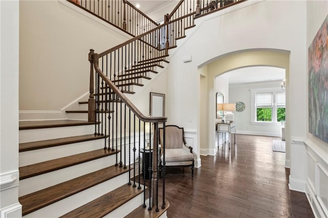 1393 Kings Park Dr NW, Kennesaw, GA 30152 - stairs featuring arched walkways, wood finished floors, and a towering ceiling