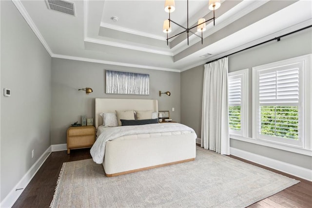 1393 Kings Park Dr NW, Kennesaw, GA 30152 - bedroom with a chandelier, wood finished floors, crown molding, a raised ceiling, and baseboards