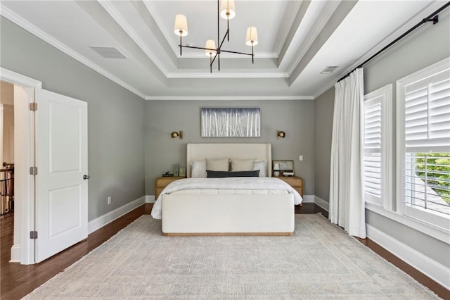 1393 Kings Park Dr NW, Kennesaw, GA 30152 - bedroom with a chandelier, a tray ceiling, wood finished floors, crown molding, and baseboards