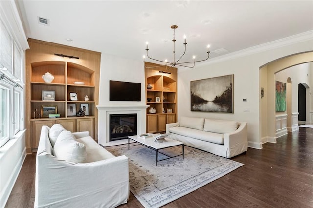 1393 Kings Park Dr NW, Kennesaw, GA 30152 - living area featuring arched walkways, built in features, baseboards, a chandelier, and wood finished floors
