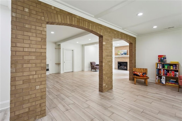 1393 Kings Park Dr NW, Kennesaw, GA 30152 - below grade area with arched walkways, a fireplace, light wood-style flooring, ornamental molding, and baseboards