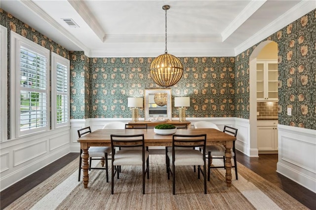 1393 Kings Park Dr NW, Kennesaw, GA 30152 - dining area featuring dark wood-style floors, a chandelier, a decorative wall, ornamental molding, and arched walkways