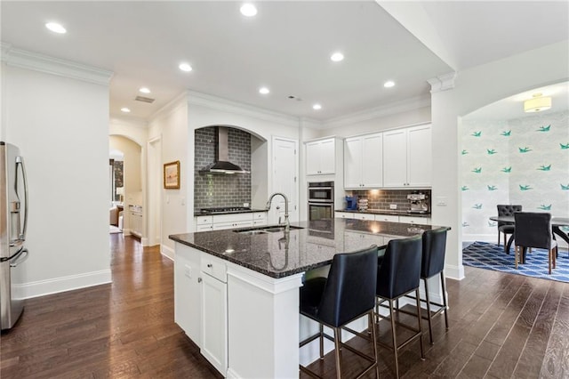 1393 Kings Park Dr NW, Kennesaw, GA 30152 - kitchen with a sink, appliances with stainless steel finishes, arched walkways, baseboards, and wall chimney range hood