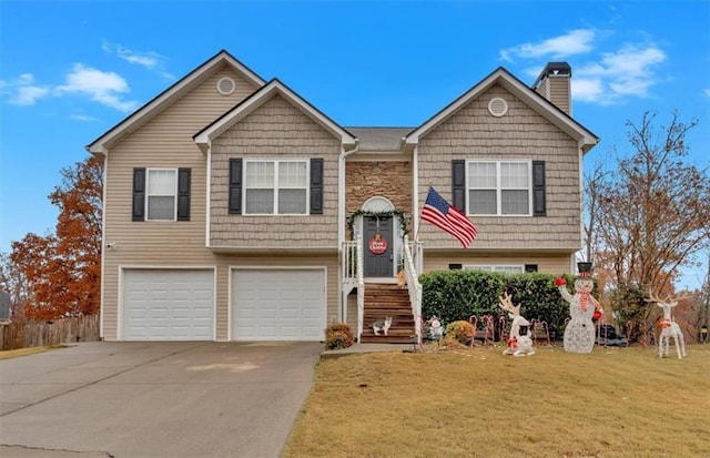 bi-level home with a front yard and a garage