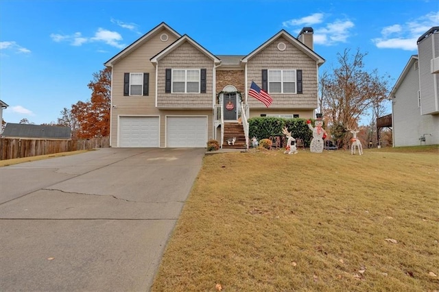 split foyer home featuring a front yard and a garage