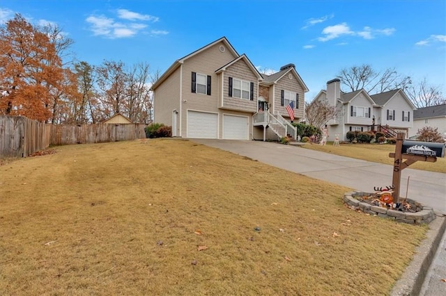 view of front of home with a front yard and a garage