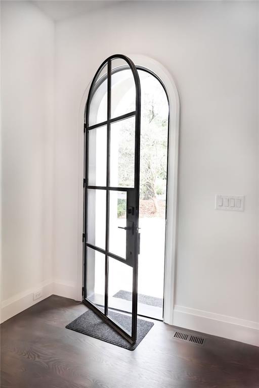 doorway to outside featuring dark hardwood / wood-style flooring