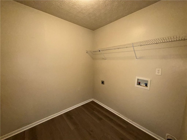 clothes washing area with dark wood-type flooring, baseboards, washer hookup, laundry area, and electric dryer hookup