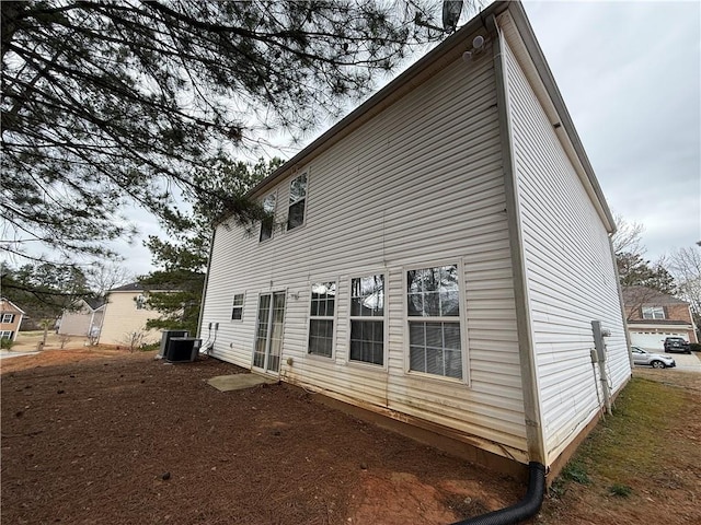 back of house featuring cooling unit