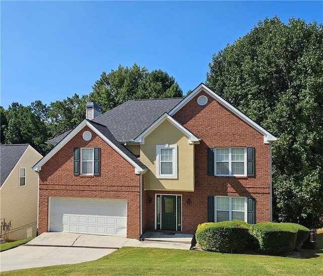 view of front of house with a front yard and a garage