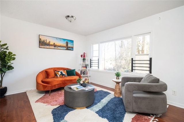 living room featuring dark wood-style flooring and baseboards