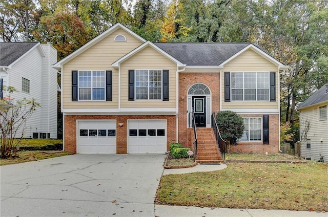 split foyer home with a garage and a front lawn