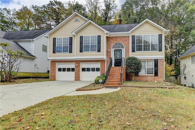 bi-level home featuring a garage and a front yard