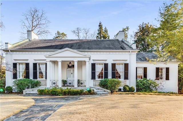 neoclassical / greek revival house with covered porch and a chimney