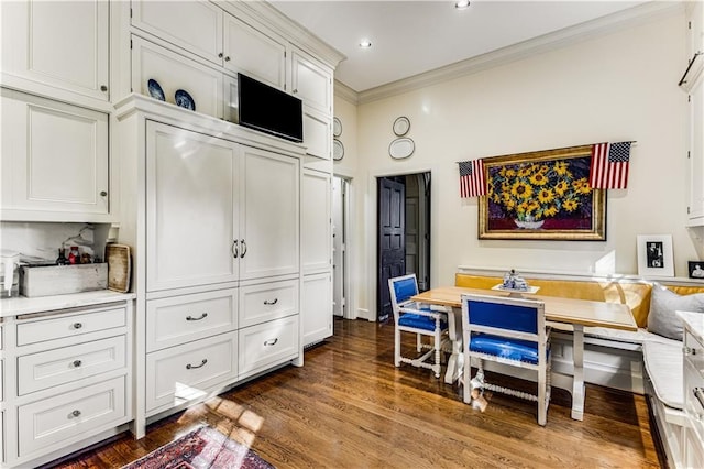 dining space featuring breakfast area, recessed lighting, dark wood-style flooring, and crown molding