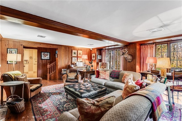 living area with stairway, visible vents, wood finished floors, and ornamental molding