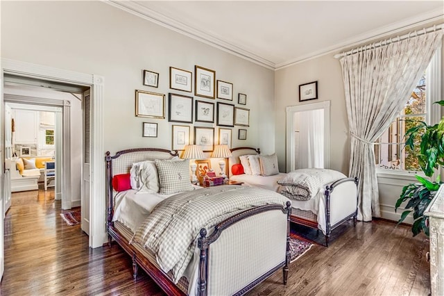 bedroom with ornamental molding, multiple windows, and wood finished floors