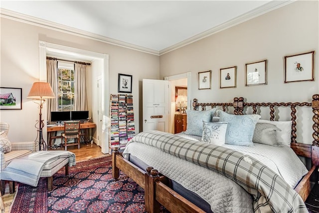 bedroom with wood finished floors and crown molding