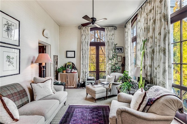 interior space featuring french doors, ceiling fan, brick wall, and crown molding