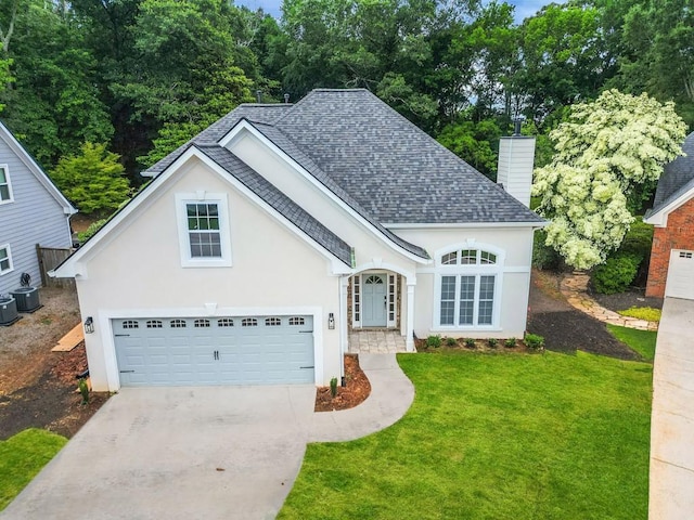 1950 Stethem Fry, Alpharetta, GA 30022 - view of front of house featuring roof with shingles, driveway, a front yard, stucco siding, and a chimney