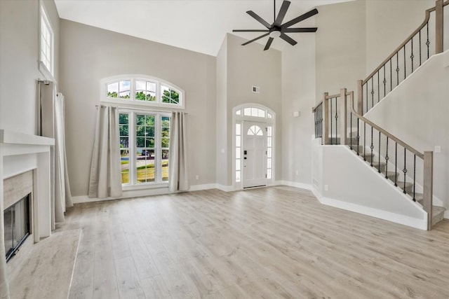 1950 Stethem Fry, Alpharetta, GA 30022 - foyer entrance with high vaulted ceiling, ceiling fan, wood finished floors, stairs, and a premium fireplace