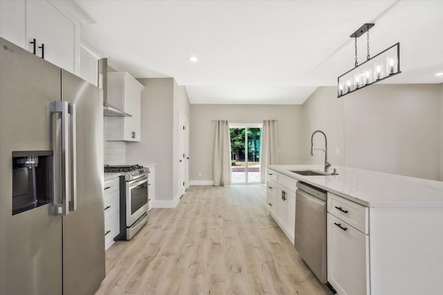 1950 Stethem Fry, Alpharetta, GA 30022 - kitchen featuring appliances with stainless steel finishes, light wood-type flooring, white cabinets, decorative light fixtures, and a center island with sink