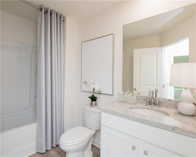 2686 NE Almand Ln NE, Conyers, GA 30013 - full bathroom featuring vanity, shower / bath combo, and wood finished floors