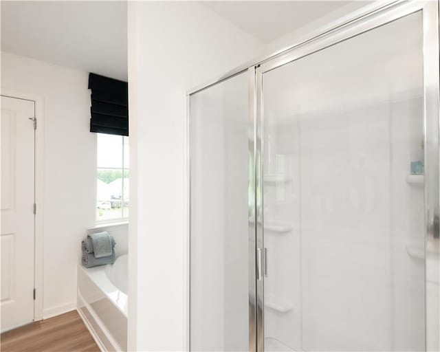 2686 NE Almand Ln NE, Conyers, GA 30013 - full bathroom with a shower stall, a bath, and wood finished floors