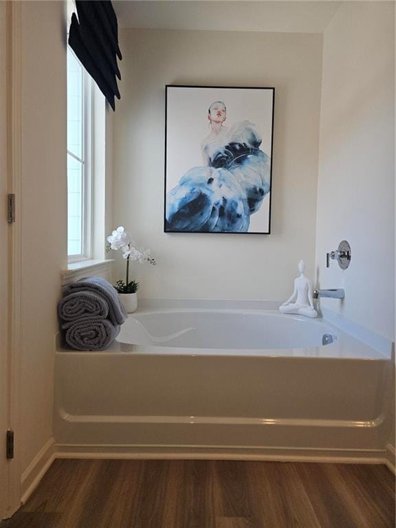 2686 NE Almand Ln NE, Conyers, GA 30013 - bathroom with wood finished floors and a bath