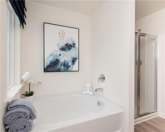 2686 NE Almand Ln NE, Conyers, GA 30013 - full bath with a bath, a shower stall, and wood finished floors