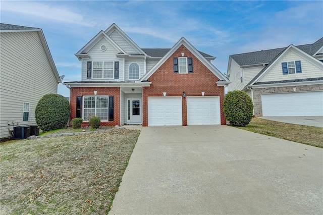 traditional home featuring central air condition unit, an attached garage, concrete driveway, and brick siding