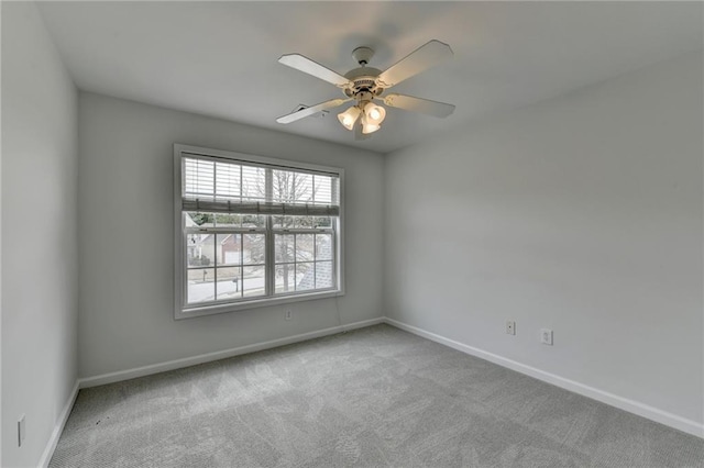 unfurnished room featuring ceiling fan, carpet, and baseboards