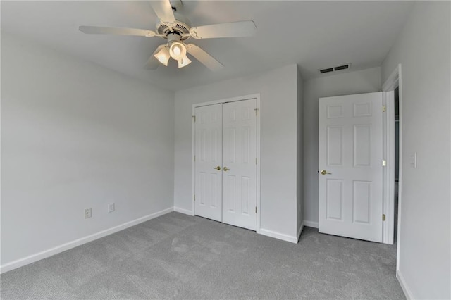 unfurnished bedroom with ceiling fan, visible vents, baseboards, a closet, and carpet