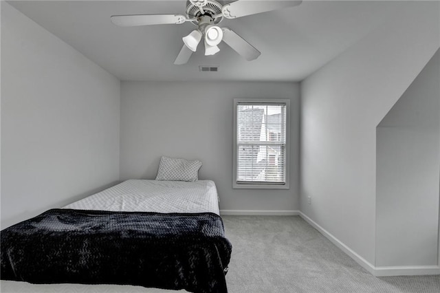 bedroom featuring light carpet, ceiling fan, visible vents, and baseboards