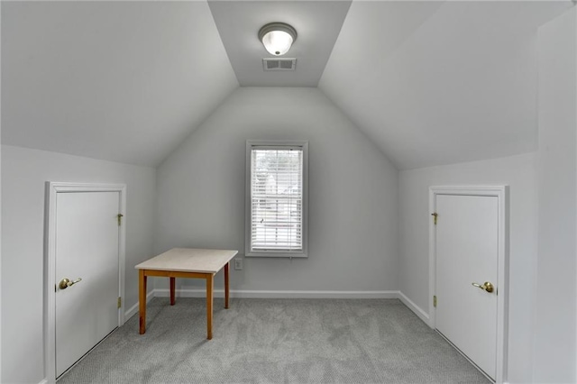 bonus room with baseboards, visible vents, vaulted ceiling, and light colored carpet