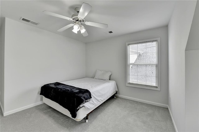 carpeted bedroom with baseboards, visible vents, and ceiling fan